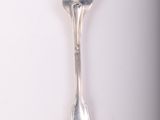 a silver spoon and a fork on a white surface