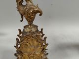pair of antique brass candlesticks in the form of peacocks
