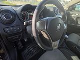 the interior of a car with a steering wheel and dashboard controls