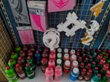 many bottles and cans of soda on a shelf