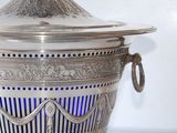 a silver container with a blue light inside of it