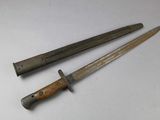 pair of old knives on a white surface with a wooden handle