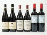 plusieurs bouteilles de vin sont alignées sur une surface blanche