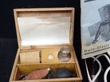 a wooden box with a book and a mouse in it