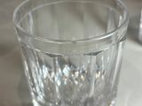 a glass of water sitting on a plate on a table