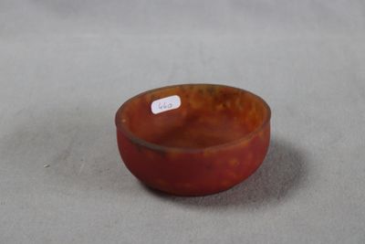 a small bowl with a tag on it on a table