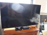 a flat screen tv sitting on top of a wooden dresser
