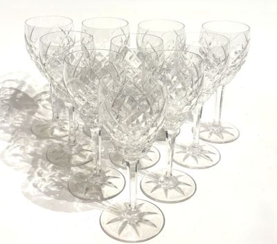many wine glasses lined up on a white surface