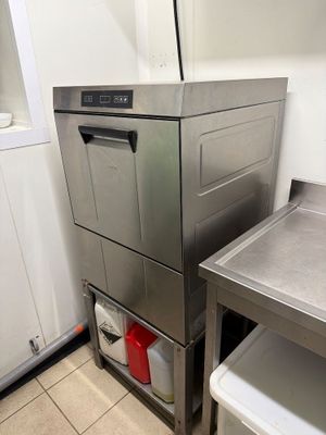 a stainless steel dishwasher sitting next to a sink in a kitchen
