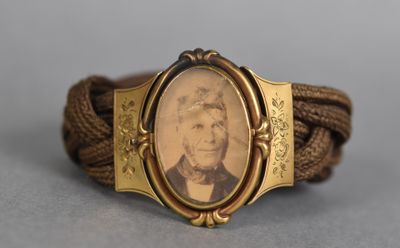 a close up of a bracelet with a picture of a man on it