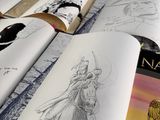 an open book with a drawing of an angel on it
