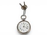 an old pocket watch hanging from a chain on a white background