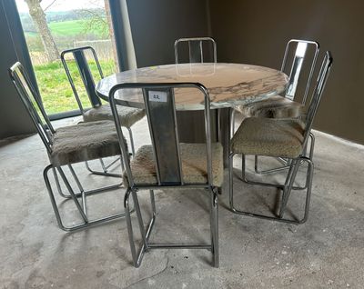 a table and chairs in a room with a glass door