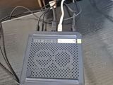 a small radio sitting on a table with a charger attached to it