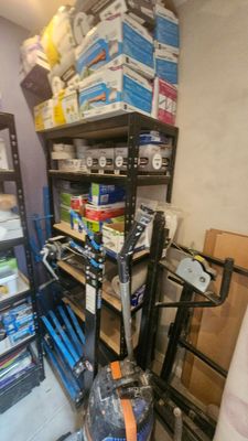 a small room with a lot of items on the shelves