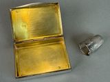 a small metal object that is sitting next to a small metal object