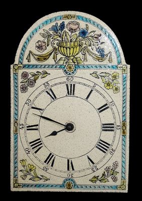 a clock that has been decorated with flowers and leaves