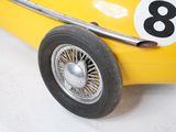 a yellow toy car with a number eight on it