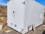 a white trailer that has a sign on top of it