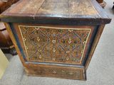 an old wooden chest with a decorative design on it