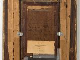an old picture frame with a piece of paper taped to it