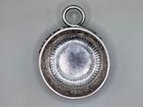 a silver plate with a circular design on it