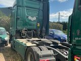 a green truck that is parked on the side of the road