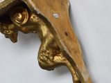 a gold statue of a man with a hat on it ' s head