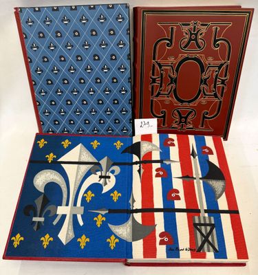 three books are lined up on a table with a red, white and blue cover