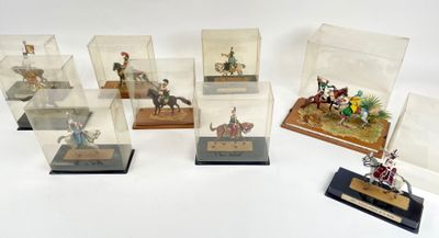 several miniature figurines of people riding horses and horses in glass cases