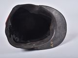 a close up of a black hat on a white surface