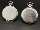 a pair of silver pocket watches on a black surface