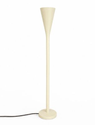 the floor lamp is white and has a black cord attached to it
