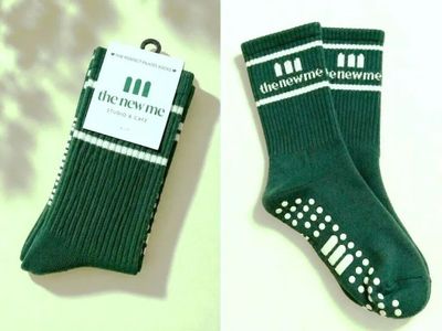 two pairs of green socks with white stripes and a tag on them
