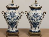 pair of blue and white vases sitting on top of a wooden table