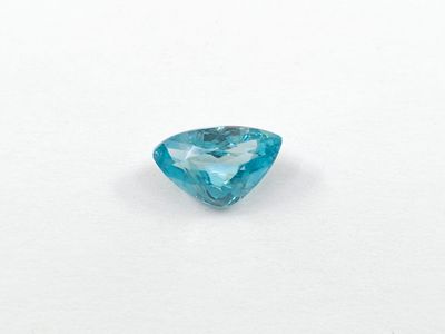 a close up of a blue diamond on a white surface