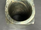 a small hole in the floor that is filled with water