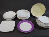 many plates and bowls sitting on a black table
