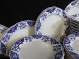 a lot of blue and white plates stacked on top of each other
