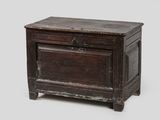 an old wooden chest sitting on top of a white surface
