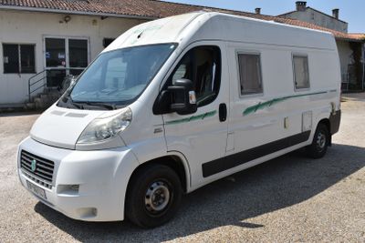 a white van that is parked in front of a building