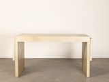 a wooden table in a room with a white wall