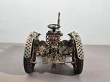 a toy car made out of metal parts on a table