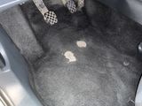 a dirty carpet in a car that has been cleaned
