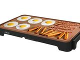 an image of an electric griddle with eggs and pretzels