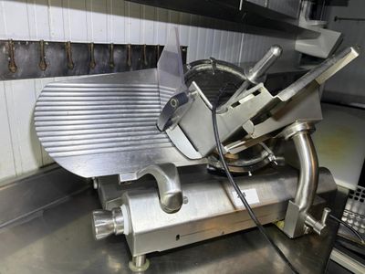 an image of a meat slicer in a commercial kitchen