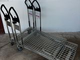 two luggage carts sitting next to each other on top of a cement floor