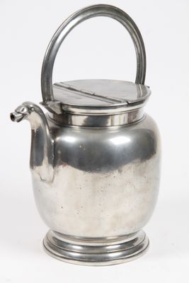 a silver tea pot with a handle on a white background