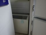 a refrigerator and a freezer in a small room