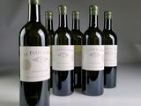 six bottles of wine are lined up on a table